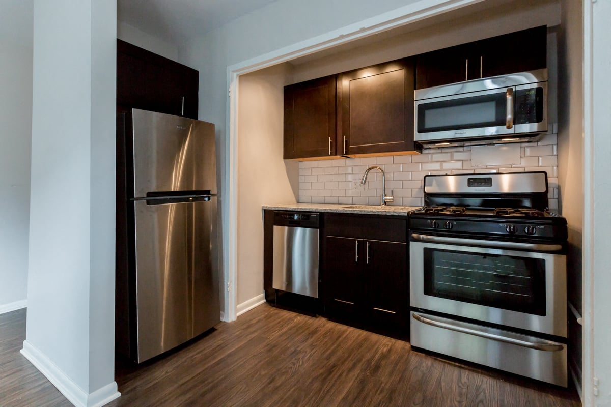 stainless steel appliances kitchen hardwood floors renovated apartment home hyde park chicago